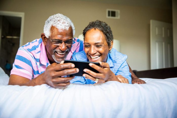 Couple watching show on smartphone 1024x683