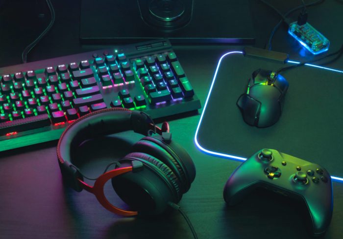 Gamer desktop setup with headphones mouse controller and RGB keyboard and mousepad 1024x716
