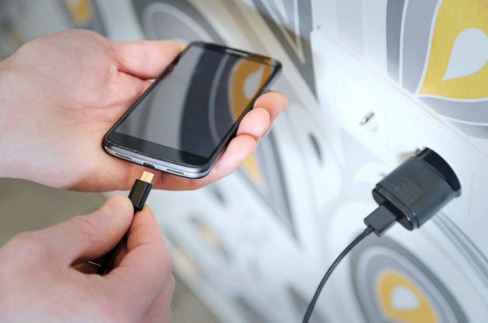 Person Charging Their Phone 1024x679